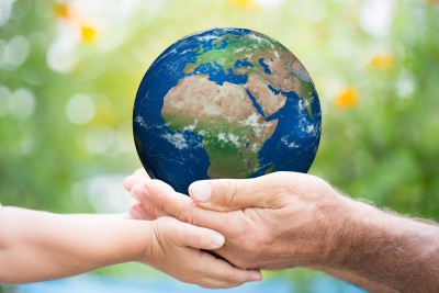 two hands holding planet earth